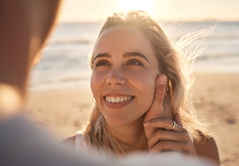 Image showing Affection, love and couple at the beach for a date, honeymoon and quality time by the sea. Travel, relax and face of a woman with an embrace from a man while on holiday by the ocean to relax