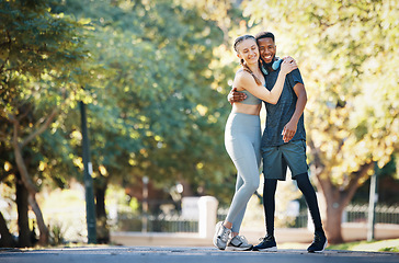 Image showing Workout, couple and hug in park portrait for exercise, fitness and walk break with smile for affection. Interracial, love and wellness of happy people dating on cardio rest together in New York.