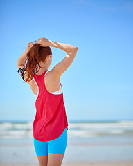 Image showing Fitness, beach and running with a sports woman by the sea or ocean for summer exercise with mockup. Nature, freedom and workout with a female athlete or runner cardio training alone on the coast