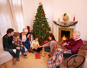 Image showing Big family, Christmas and giving present or gift with children, parents and grandparents together for love, care and celebration. Men, women and kids in house at fireplace to celebrate holiday