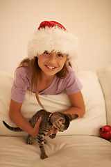 Image showing Girl, Christmas celebration and kitten gift in bedroom to celebrate festive holiday. Happy child, pet cat as party present and animal care or kids happiness in bed, celebrating xmas vacation season