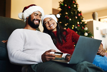 Image showing Christmas, couple and couch with laptop, credit card and together for finance, festive season and ecommerce in lounge. Xmas, man and woman for payment, investments and online banking for transactions