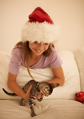 Image showing Christmas, child and cat kitten for present or gift of love for happiness, care and holiday celebration in family home. Smile of girl excited and happy for xmas animal in house while playing together