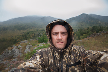 Image showing Caucasian man in the mountain making selfie