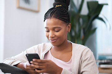 Image showing Black woman, social media smartphone and living room sofa relax, typing and online connection, reading notification and iot website. Young african female, mobile app and internet tech on 5g home wifi