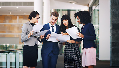 Image showing Business people team reading paperwork, documents and planning strategy, financial information or company analytics in modern office. Diversity, corporate workers and paper reports, analysis and idea