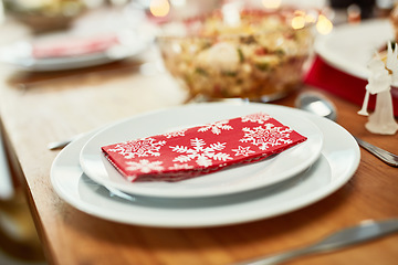 Image showing Youre invited. Christmas, celebration and holiday table plate for food, party and dining place setting zoom. Dining room, lunch or dinner to celebrate xmas vacation with festive red snowflake napkin.