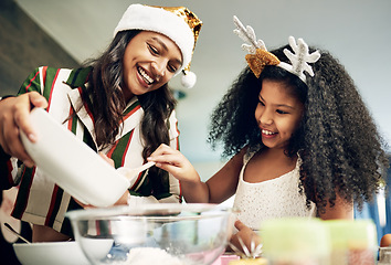 Image showing Christmas, love and girl baking with mother in kitchen to make festive cookies, biscuits and treats. Black family, love and mom bake with child enjoying festival celebration, holiday and vacation