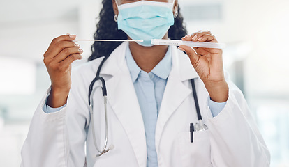 Image showing Doctor, covid test and medical healthcare expert working at a hospital, analysis of virus results and face mask for safety at clinic. Hands of African nurse doing professional corona testing