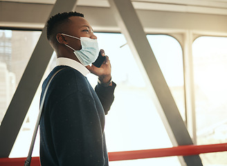 Image showing Phone, train and corporate businessman in covid pandemic mask and suit on call while traveling to work alone. Professional African male startup entrepreneur walking on his daily morning city commute