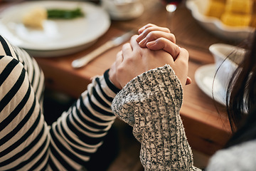 Image showing Hands, pray and family at a table for food, blessing and gratitude before sharing a meal in their home together. Hand holding, worship and people praying before eating, prayer and religious respect