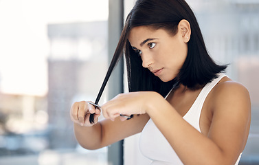 Image showing Haircut, beauty and woman with scissors in bathroom grooming and trim hair for trendy hairstyle. Hair care, diy makeover and girl with strand in hand to cut split end, unhealthy and damaged tips