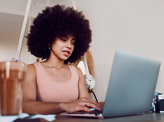 Image showing Black woman afro, laptop and designer working, studying or typing email in remote work at home. Stylish African American female freelancer busy on computer in design course or business research