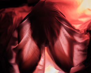Image showing Red lighting, dark and person with fabric for depression, sadness and mental health problems. Creative art, psychology and sheet over head for loneliness, isolation and adult suffering with anxiety