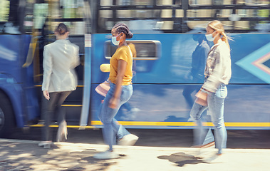 Image showing Women, covid travel and bus stop in city morning commute, public transportation or local travelling in motion blur. Diversity, passenger and covid 19 face mask in vehicle healthcare safety compliance