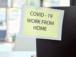 Image showing Covid, sign and work from home at the office for health and safety rules or regulations during pandemic. Label post of corona virus restrictions for working remote, quarantine or control at workplace