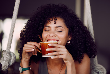 Image showing Happy black woman, drinking coffee and relax in cafe, restaurant and peace, freedom and easy lifestyle. Female happy customer enjoying cup of tea, cappuccino and warm beverage in coffee shop alone