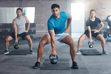 Image showing Fitness, kettlebell weight and people doing an exercise for strength, wellness or health together in a gym. Sports, motivation and athletes doing a squat workout with personal trainer in sport studio