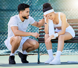 Image showing Tennis, support and loss with a sports woman feeling sad while a male athlete tries to console or comfort her. Sad, fail and loser with a young female tennis player sitting on a bench after a game