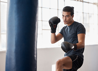 Image showing Fitness, boxing and man training for a fight competition, workout or match with a boxing bag in the gym. Sports, motivation and athlete boxer doing MMA exercise to practice in fighting dojo or studio