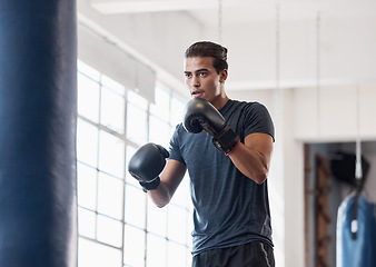 Image showing Fitness, training and boxing with man in gym for workout, exercise and sports stamina. Cardio, energy and power with athlete and punching bag for martial arts, performance and action in dojo club
