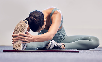 Image showing Yoga, fitness and stretching woman on floor for body wellness, exercise and healthy lifestyle with wall mockup for marketing. Sports athlete girl with foot or sneakers in cardio, pilates and workout