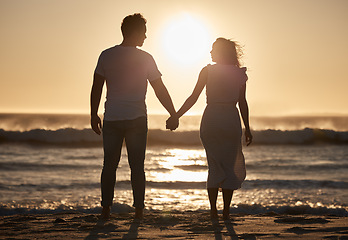 Image showing Beach silhouette, couple holiday and sunset with love, hold hands and love together, support and holiday. Man, woman and vacation at ocean, travel and romance for anniversary, honeymoon and sea trip