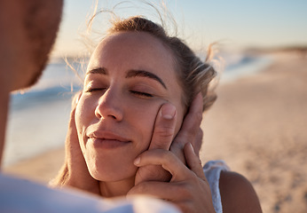 Image showing Woman, face and hands for couple at beach for romance, relax or embracing happy relationship together. Happy female with smile relaxing in loving care or enjoying summer vacation love by the ocean