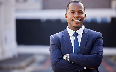 Image showing Corporate, black man and smile in portrait with arms crossed in city, town or metro in government. African politician, happy and vision with motivation, professional confidence or leadership in suit