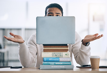 Image showing Laptop, books and studying man with confused, stress or decision for business research, planning and project proposal idea at desk. Choice, knowledge and student on pc for accounting scholarship info