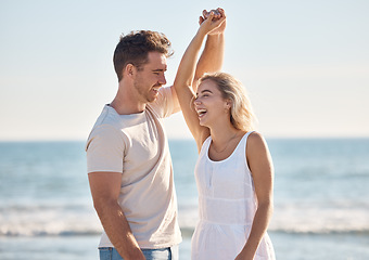 Image showing Beach, love and dance with a young couple in nature, happy together during a date or summer vacation. Smile, travel and romance with a man and woman dancing by the sea or ocean while bonding
