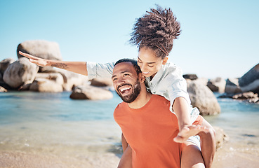 Image showing Love, beach and man piggy back woman, smile and happy together for romance, holiday and vacation outdoor. Romantic, black couple and bonding being loving, enjoy seaside getaway, laugh or happiness.