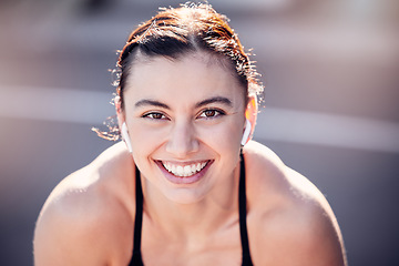 Image showing Portrait, face and fitness with a sports woman listening to music while running outdoor for cardio exercise. Happy, smile and workout with a female runner training alone for an endurance marathon