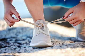Image showing Shoes, running and fitness with a sports woman tying her laces before a cardio or endurance run outdoor. Road, health and exercise with a female runner fastening her shoelaces before a workout