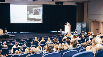 Image showing Speaker giving a talk on scientific conference. Audience at the conference hall. Business and Entrepreneurship concept.