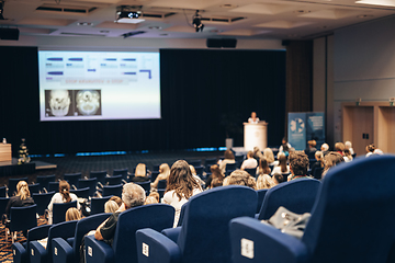 Image showing Speaker giving a talk on scientific conference. Audience at the conference hall. Business and Entrepreneurship concept.