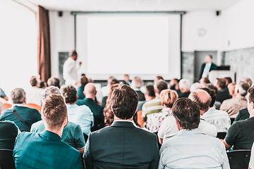 Image showing I have a question. Group of business people sitting in conference hall. Businessman raising his arm. Conference and Presentation. Business and Entrepreneurship