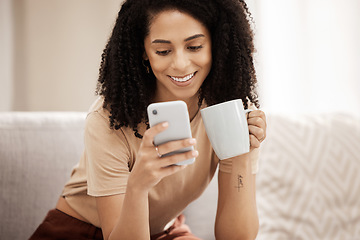 Image showing Coffee, phone and woman relax on a sofa, texting, social media and chat in a living room, happy and smile. Tea, black woman and online chatting on a couch, laughing and internet search in her home