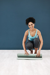 Image showing Fitness, yoga and portrait of black woman with yoga mat in studio after fitness class for pilates. Wellness, health and happy girl roll exercise mat after workout, training and stretching in gym