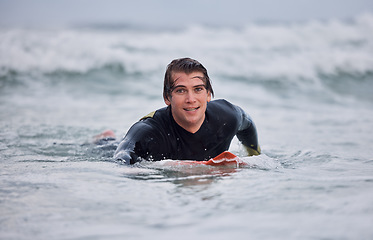 Image showing Portrait, man and surfing, ocean waves and water, summer freedom and happiness outdoors. Happy surfer guy on board, beach and sea, relax and happiness, sports adventure and vacation, swimming and sun