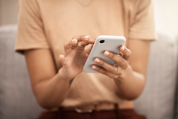 Image showing Hands, phone and woman typing on sofa in home living room, texting or scrolling social media. Tech, relax and female on couch in lounge on mobile smartphone networking or internet browsing in house.