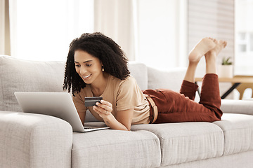 Image showing Laptop, ecommerce and customer with a black woman online shopping using her credit card in the house. Computer, living room and payment with a female consumer using technology to shop on the sofa