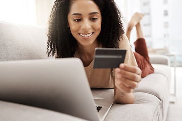 Image showing Black woman, credit card and laptop with ecommerce and online shopping, happy and relax on couch in living room. Payment, banking and e commerce payment, connection and technology with retail on web.