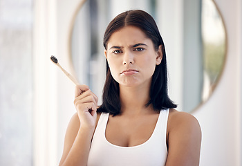 Image showing Makeup, beauty and face with a moody woman in the bathroom of her home to apply cosmetics to her skin. Portrait, make up and brush with an attractive young female feeling down or sad in the house