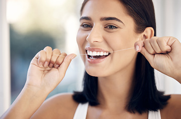 Image showing Flossing, dental and woman teeth cleaning for healthcare and wellness in a home bathroom. Healthy smile and dentist care of a person with happiness from dental care and teeth whitening results