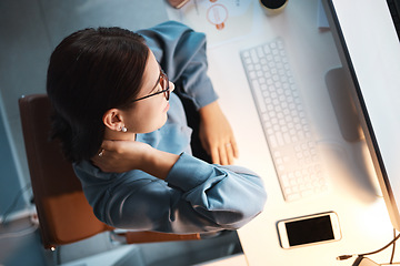 Image showing Neck pain, tired and woman in office at night working on project, report or programming issue. Injury, fatigue and muscle tension of coding expert at computer late top view with mockup screen.