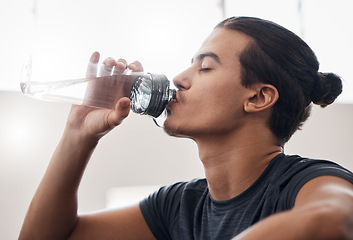 Image showing Tired, fitness or man drinking water in gym for fitness training or health workout exercise. Relax, sports or wellness athlete with water bottle for hydration, sport thirst or rest in studio