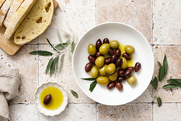 Image showing Olives, olive oil and ciabatta, top view