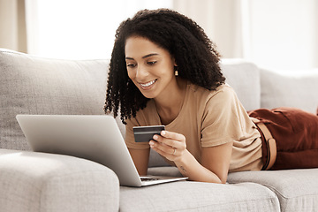 Image showing Credit card, online shopping and laptop with a black woman customer browsing internet retail for a sale. Ecommerce, computer and store website with a female consumer buying from a sofa in her home