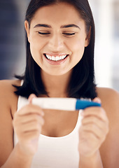 Image showing Pregnancy test, happy and smile with a woman reading the results after testing with a home kit in her bathroom. Wow, pregnant and fertility treatment with a female mother to be feeling excited